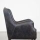 Black cow leather armchair in industrial style finished with decorative nails