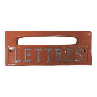 Old letters plaque in enameled terracotta