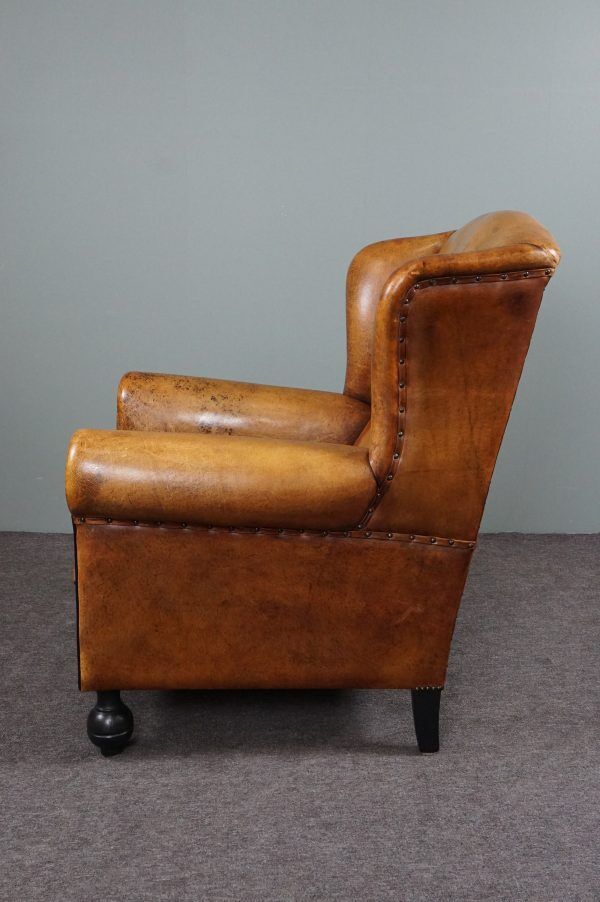 Antique armchair in patinated sheepskin