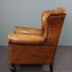 Antique armchair in patinated sheepskin