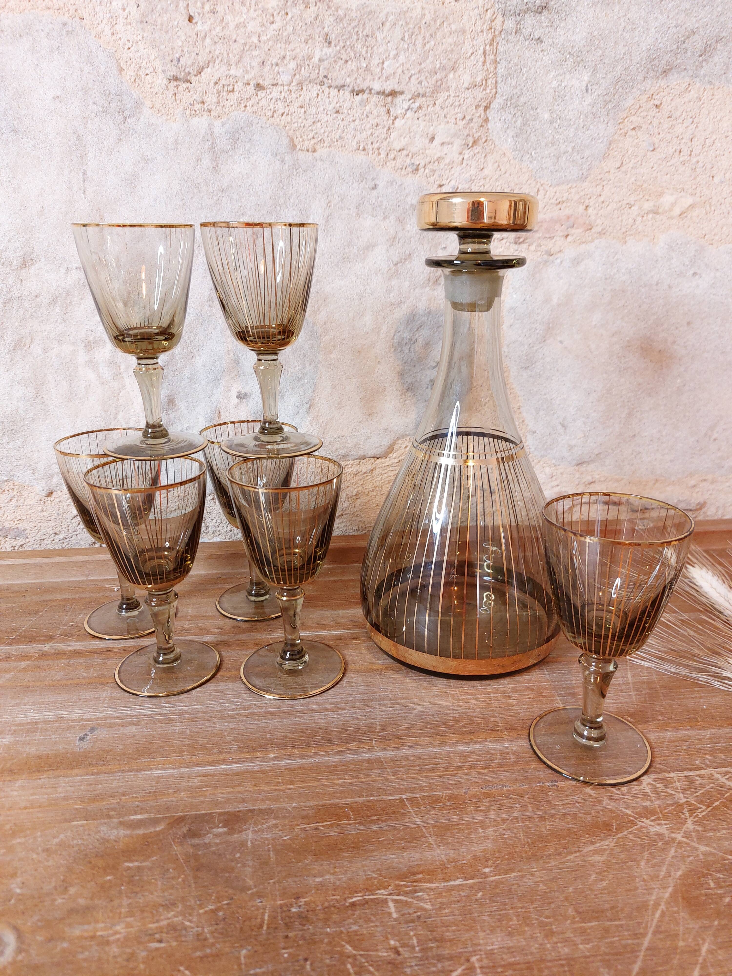 Vintage liqueur service, carafe and 7 amber brown glasses with gold edging