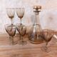 Vintage liqueur service, carafe and 7 amber brown glasses with gold edging