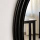 Antique oval mirror in patinated black wood