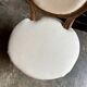 Medallion back chair in moulded wood and beige fabric.