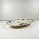 Oval half-porcelain plate from Badonviller, blue flower pattern, early 20th century.