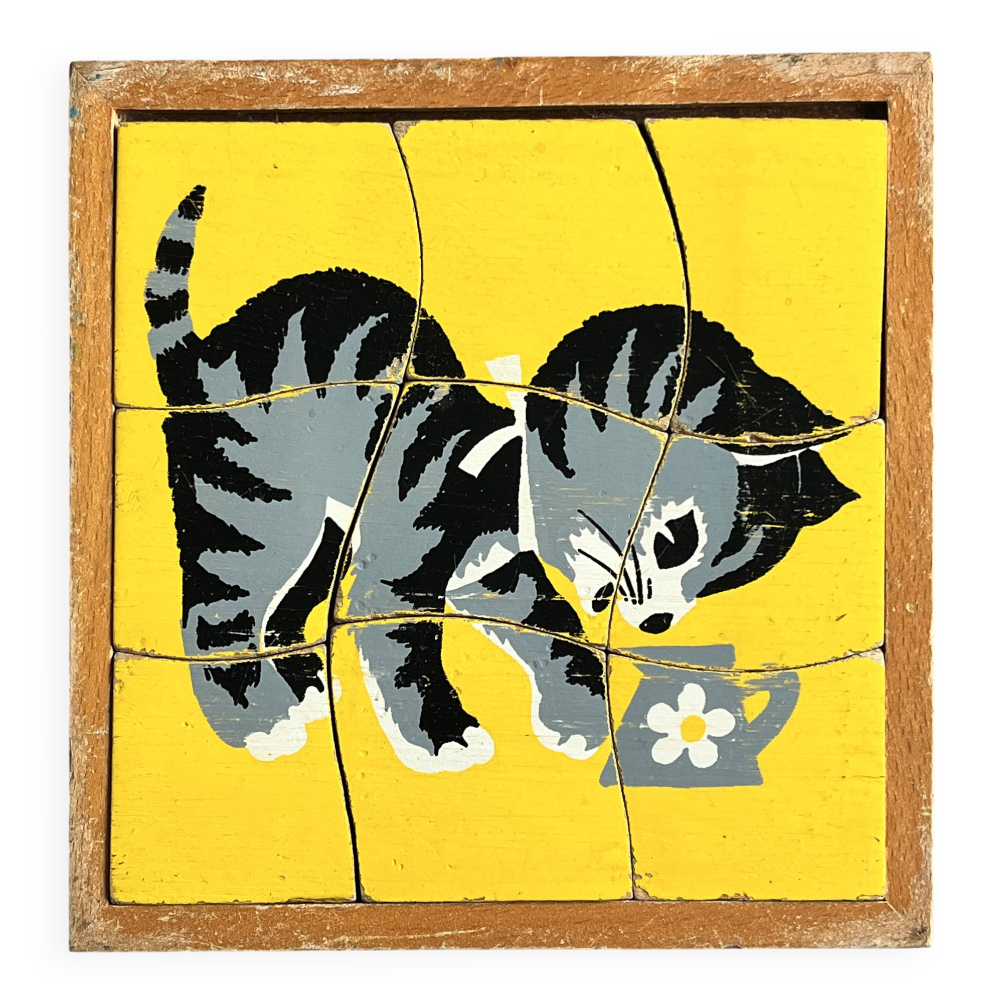 Wooden frame puzzle from the 1940s/50s depicting a cat on a yellow background.