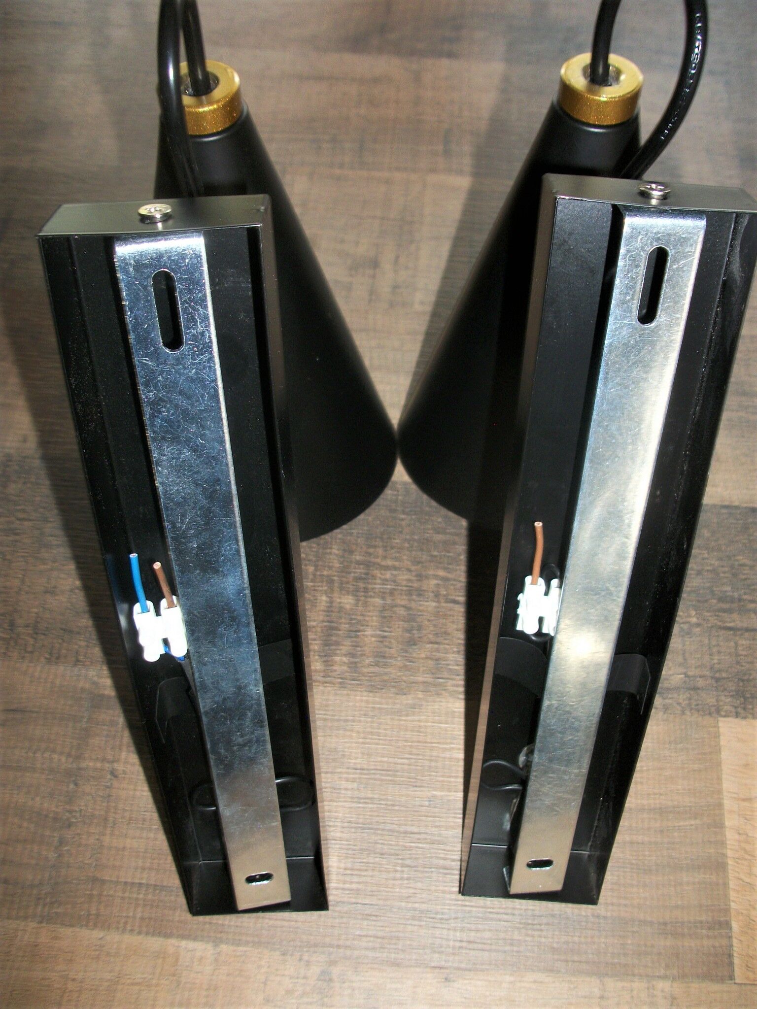 Pair of modernist sconces in black and gold metal