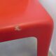 Four red fibreglass chairs from the 1970s.