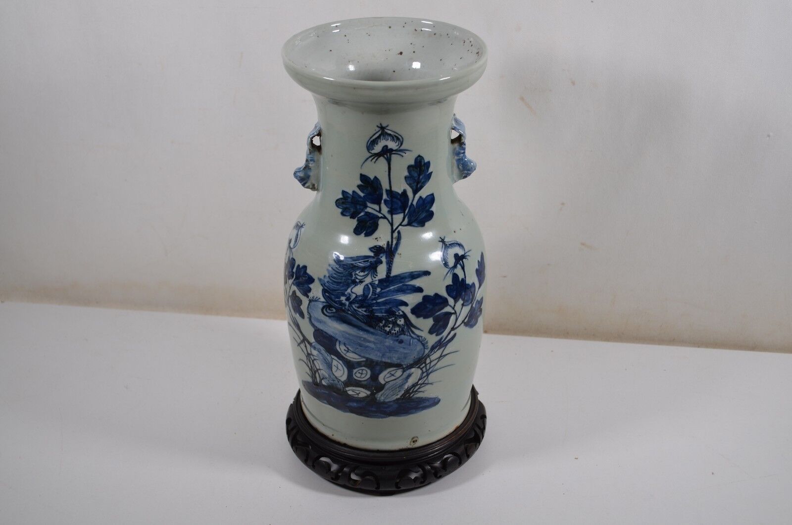 China. Porcelain mallet vase with blue and white phoenix decoration on a rock.