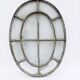 Bull's-eye window from the 19th century in iron (with opening).