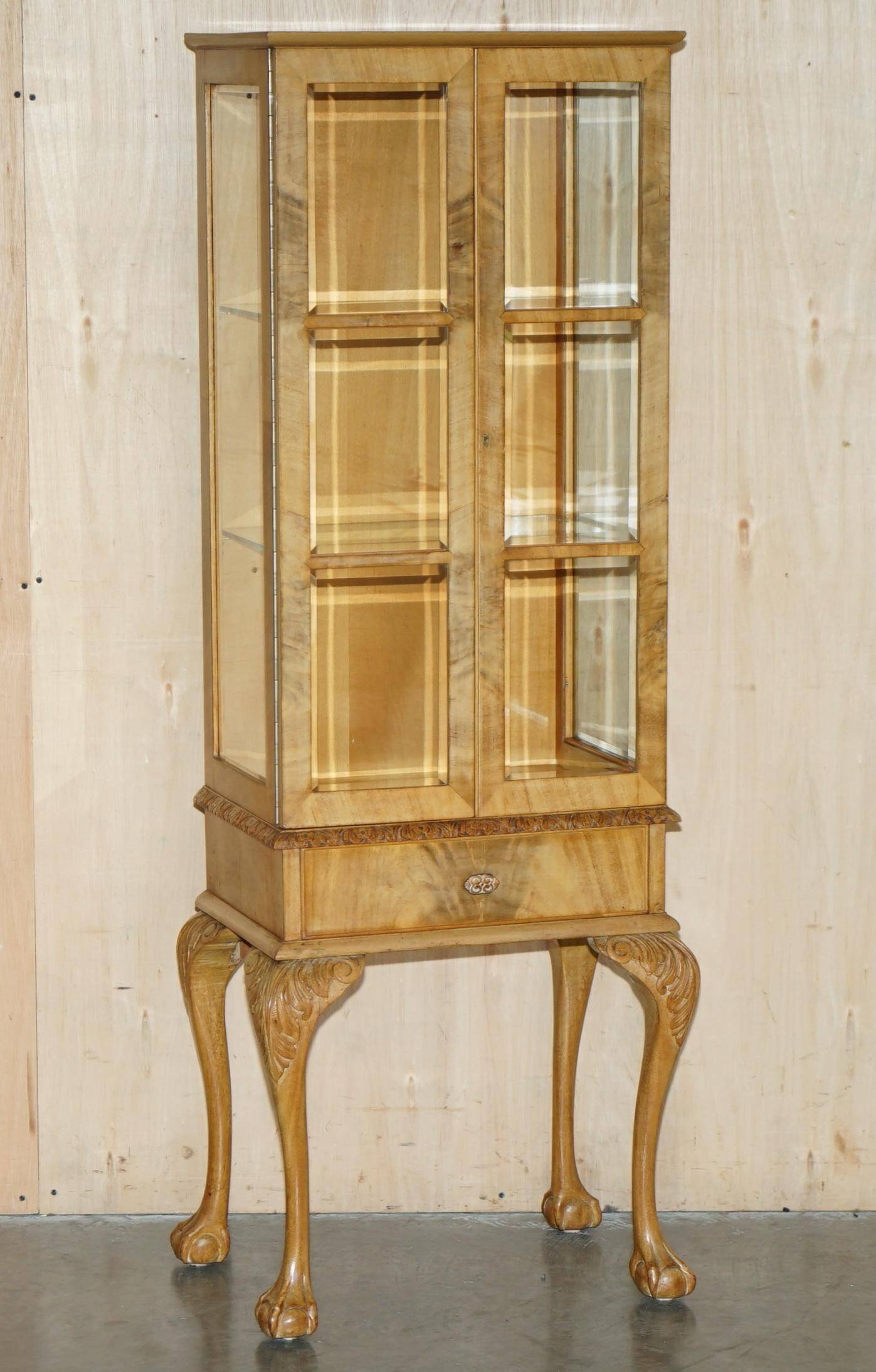 Pair of Art Deco display cabinets circa 1920 in light walnut with Cabriolet legs.