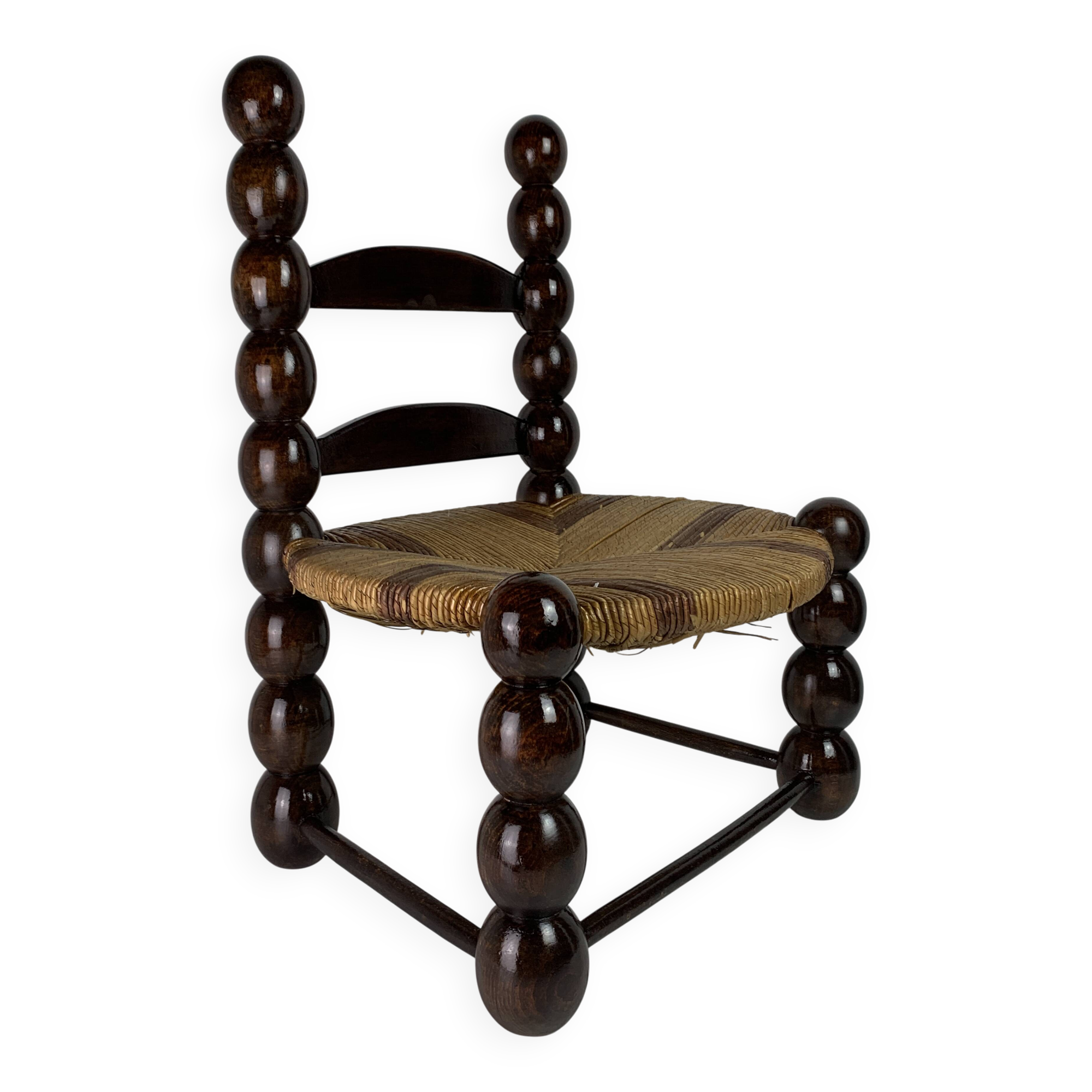 Brutalist wood turned bobbin low rush chair n the style of Charles Dudouyt