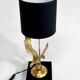 Brass lamp on black lacquered wooden base
