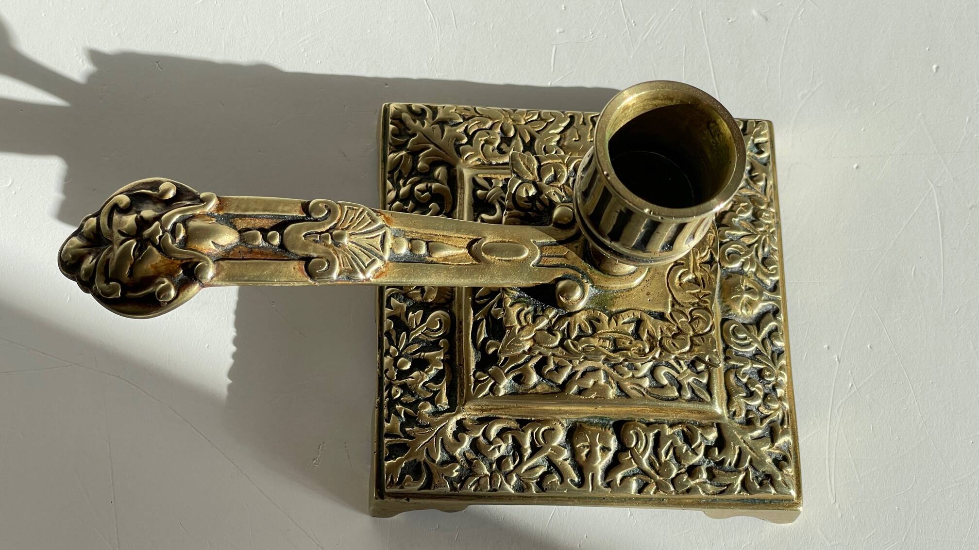 Patterned solid bronze hand candle holder