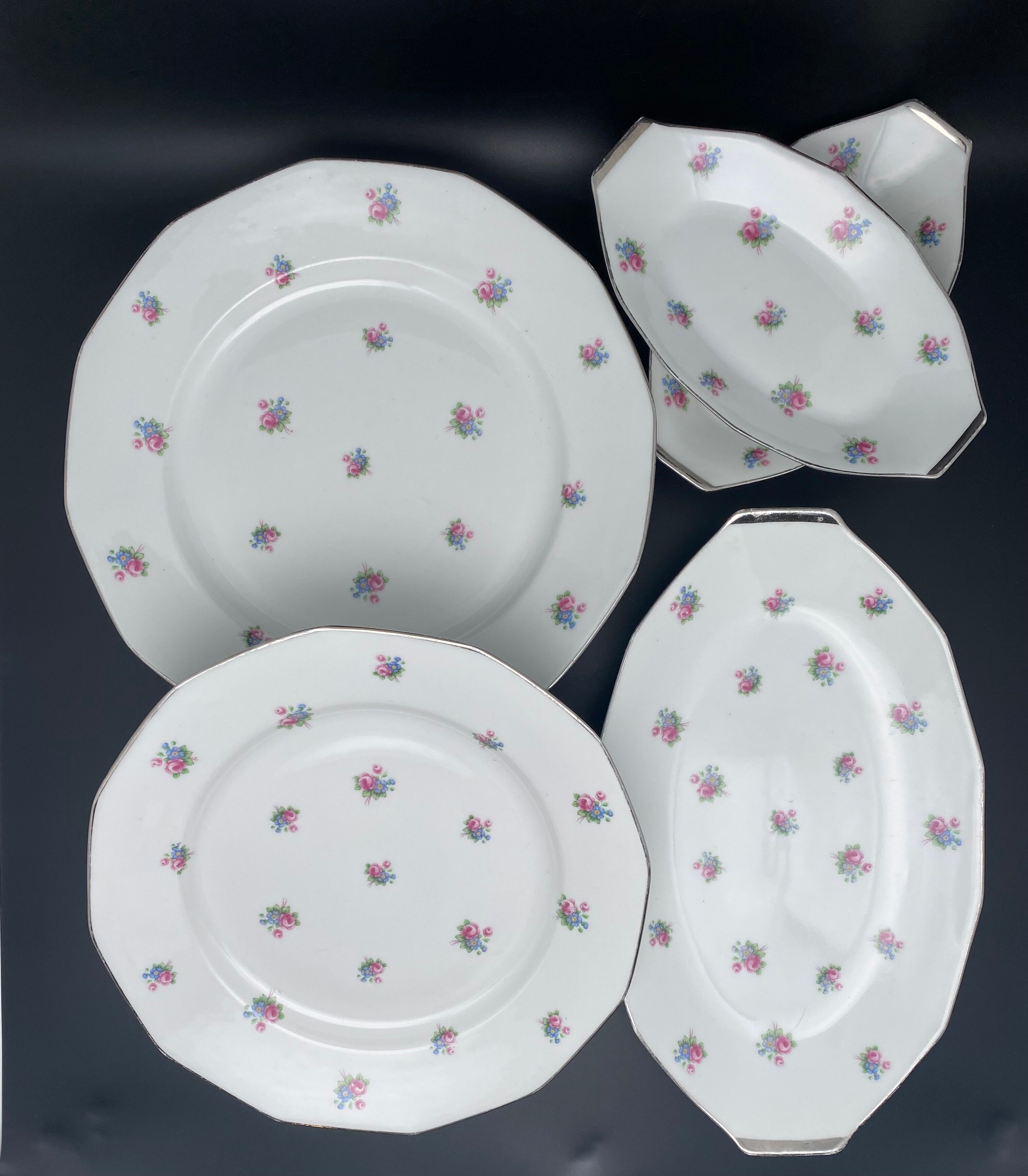 Porcelain serving dishes with small flowers and silver edging and