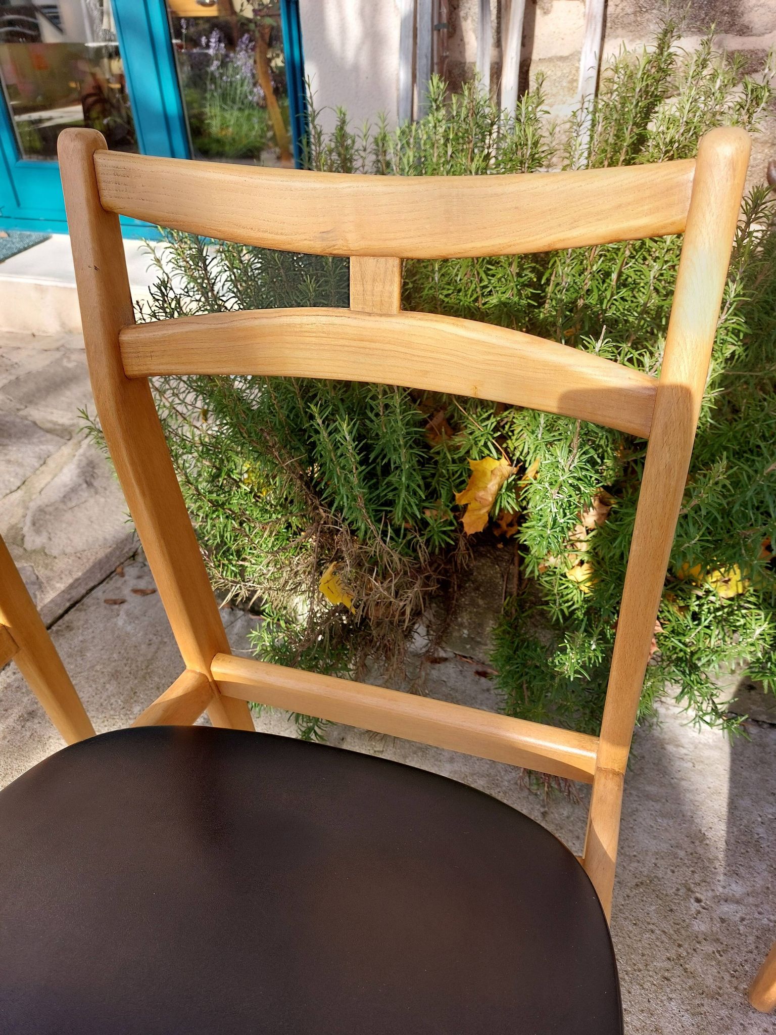 3 Scandinavian style chairs, light wood and black faux leather.