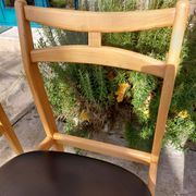 3 Scandinavian style chairs, light wood and black faux leather.