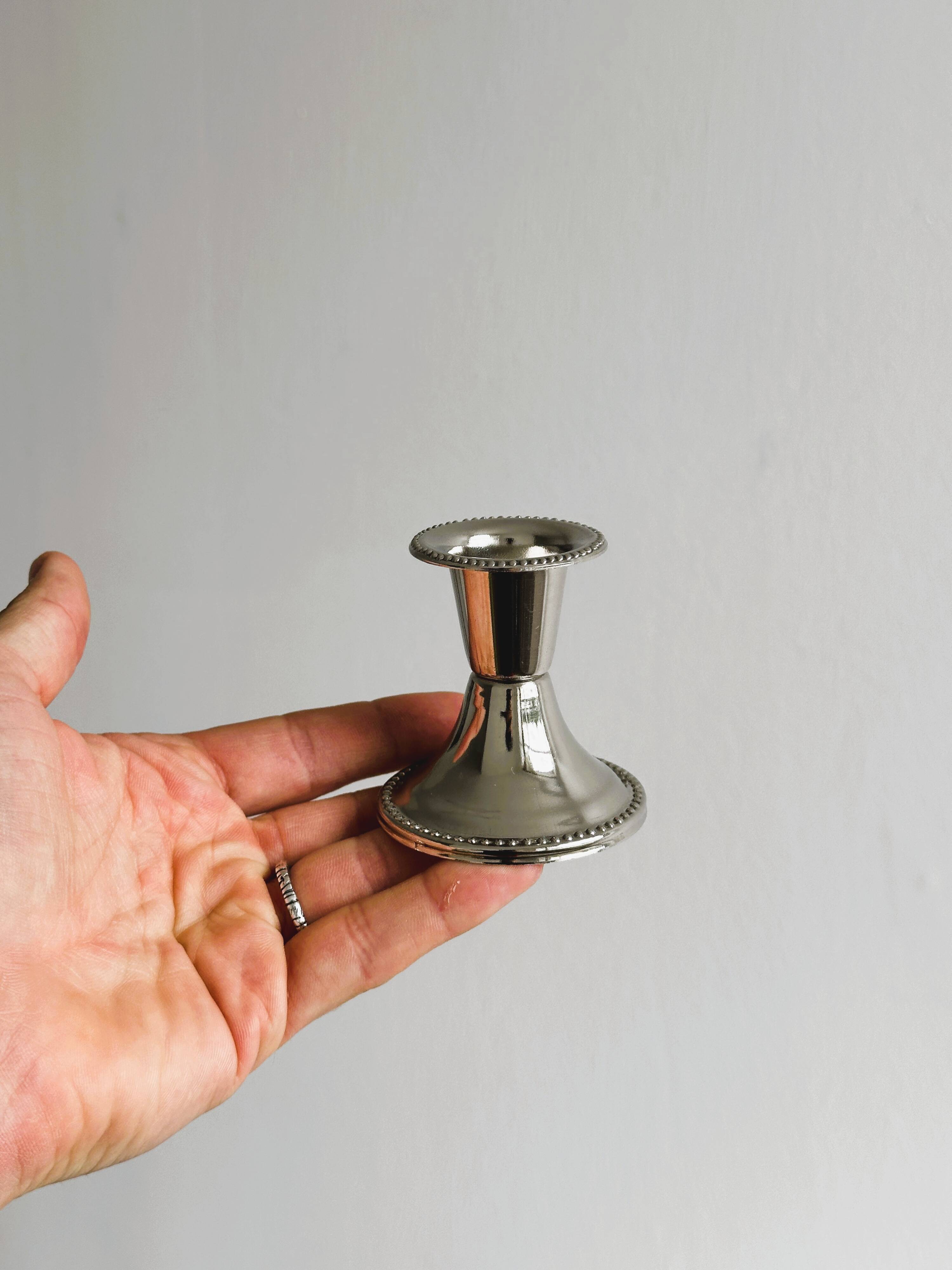 Pair of small light metal candlesticks