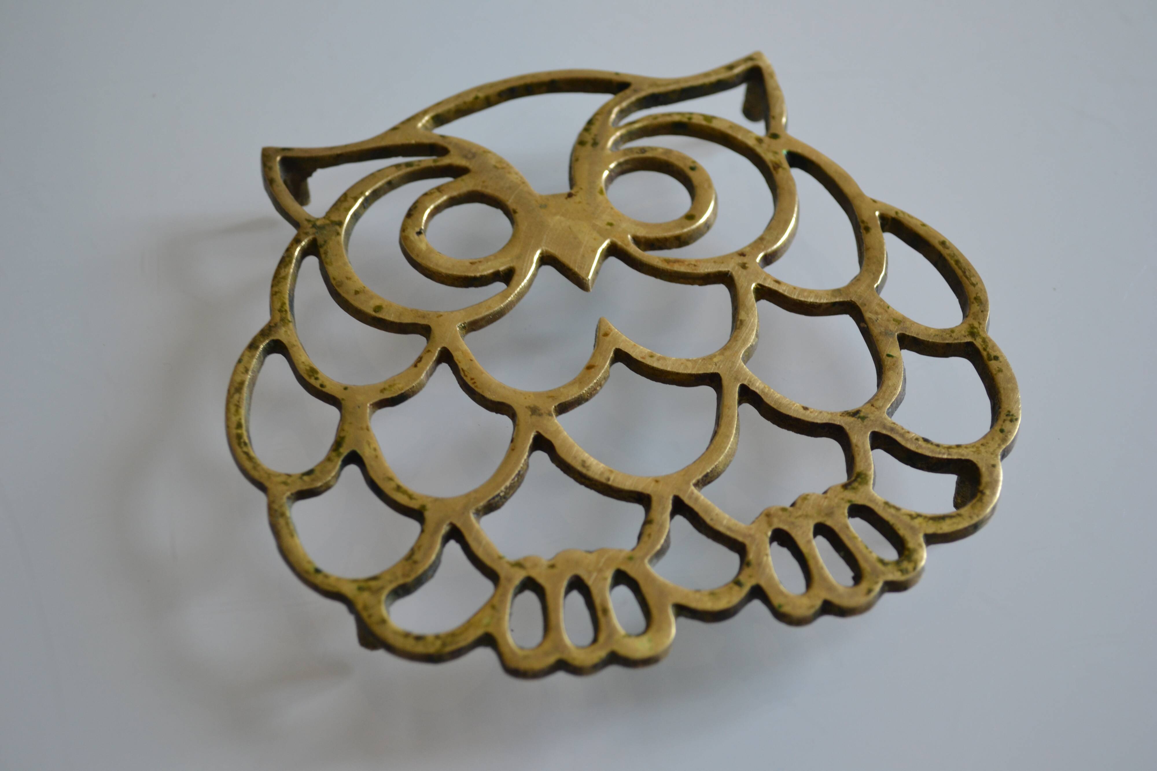 Vintage openwork brass trivet in the shape of an owl or owl