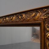 wall mirror in a decorative wooden frame.