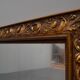 wall mirror in a decorative wooden frame.