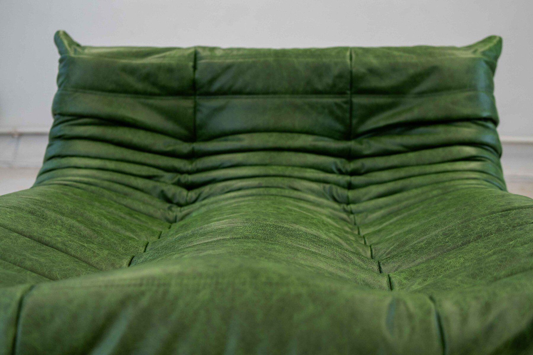 Togo chaise lounge in green leather attributed to Michel Ducaroy for Ligne Roset, 1974