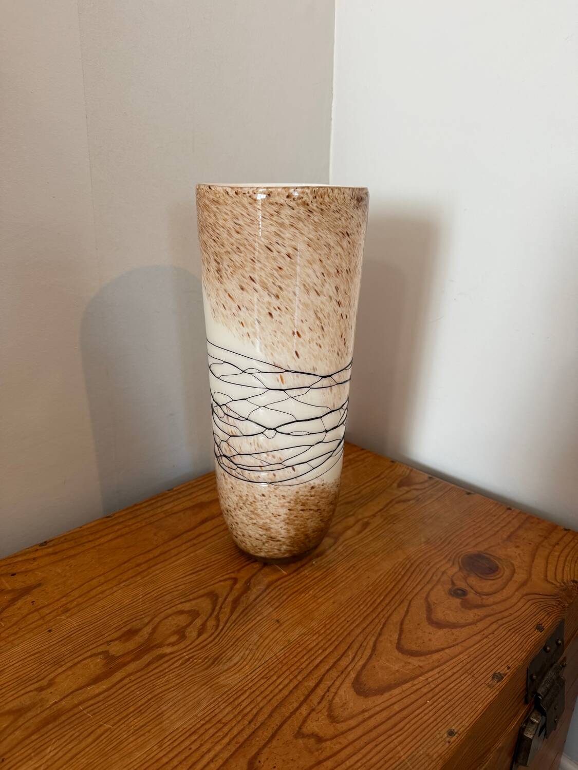 Large hand-blown glass vase in brown and beige.