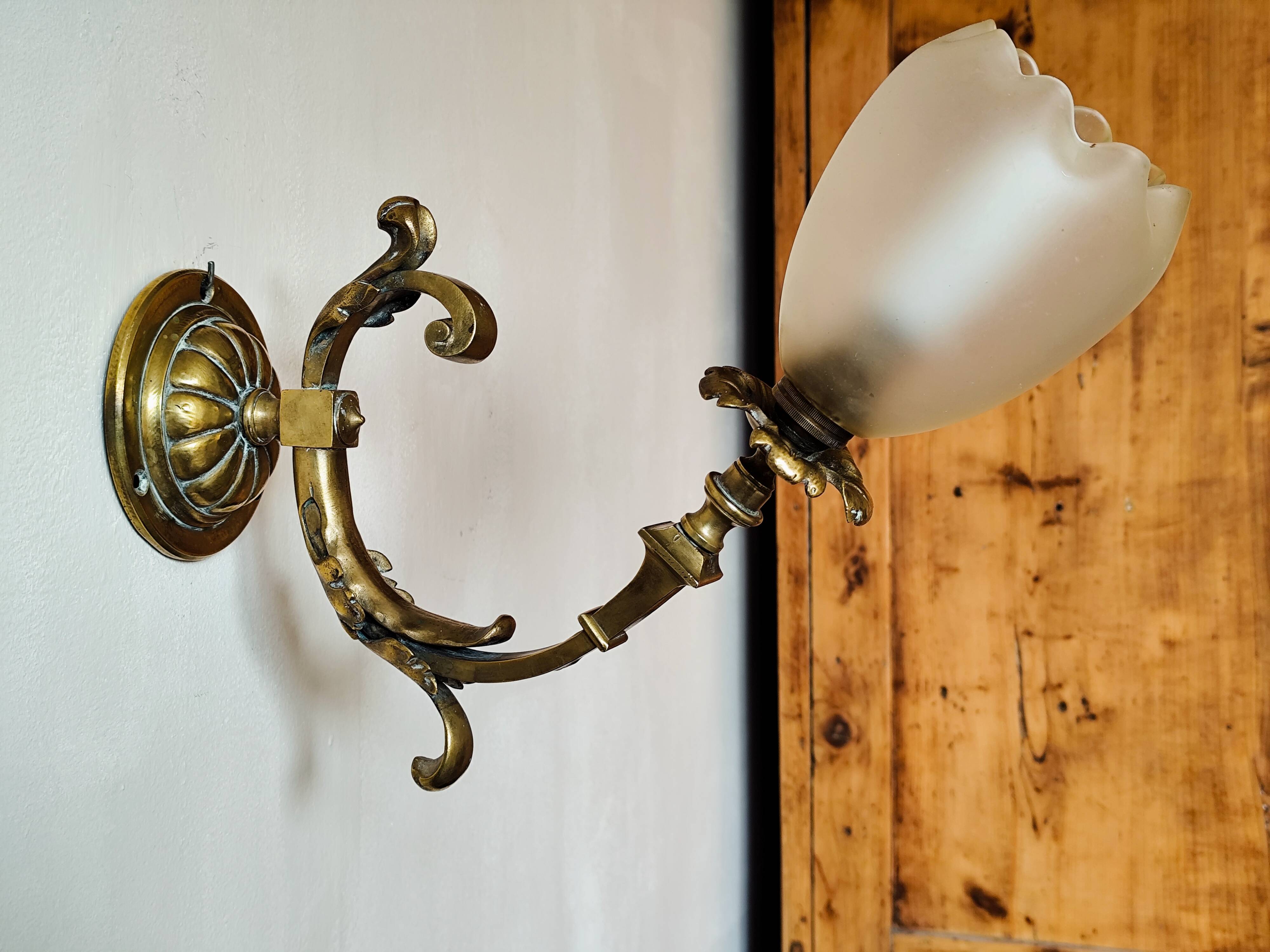 Bronze wall light with opaque glass tulip