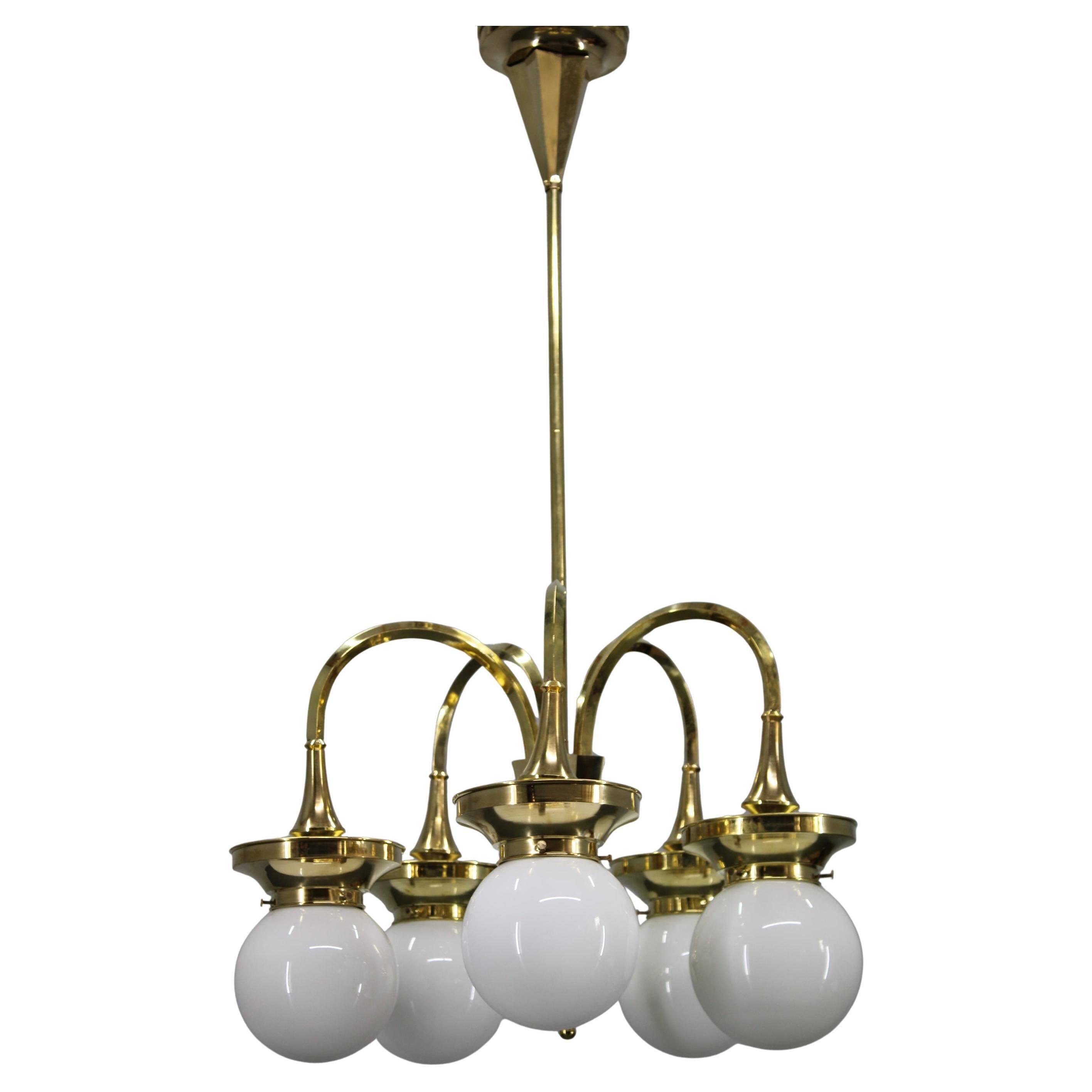 1930s Czechoslovak Art Deco brass chandelier with five opaline glass globes