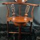 Corner armchair in solid wood with carved floral decoration featuring a bird.