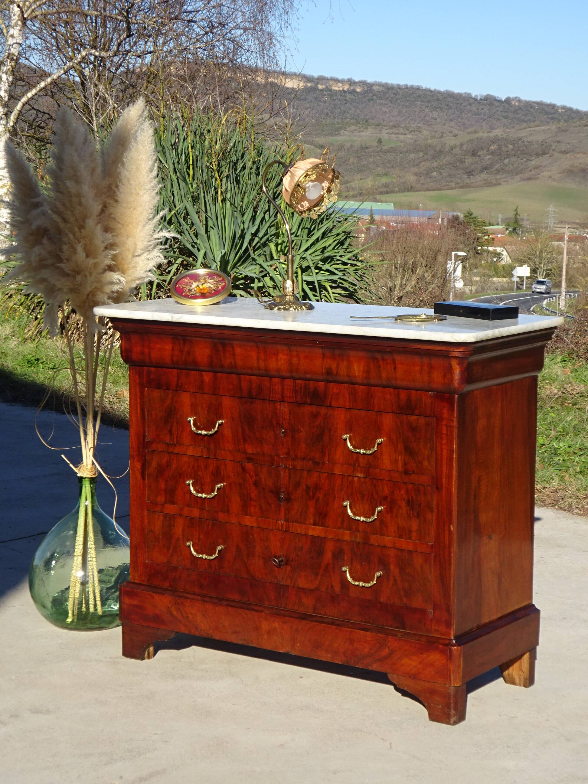 Antique mahogany chest of drawers with white marble.