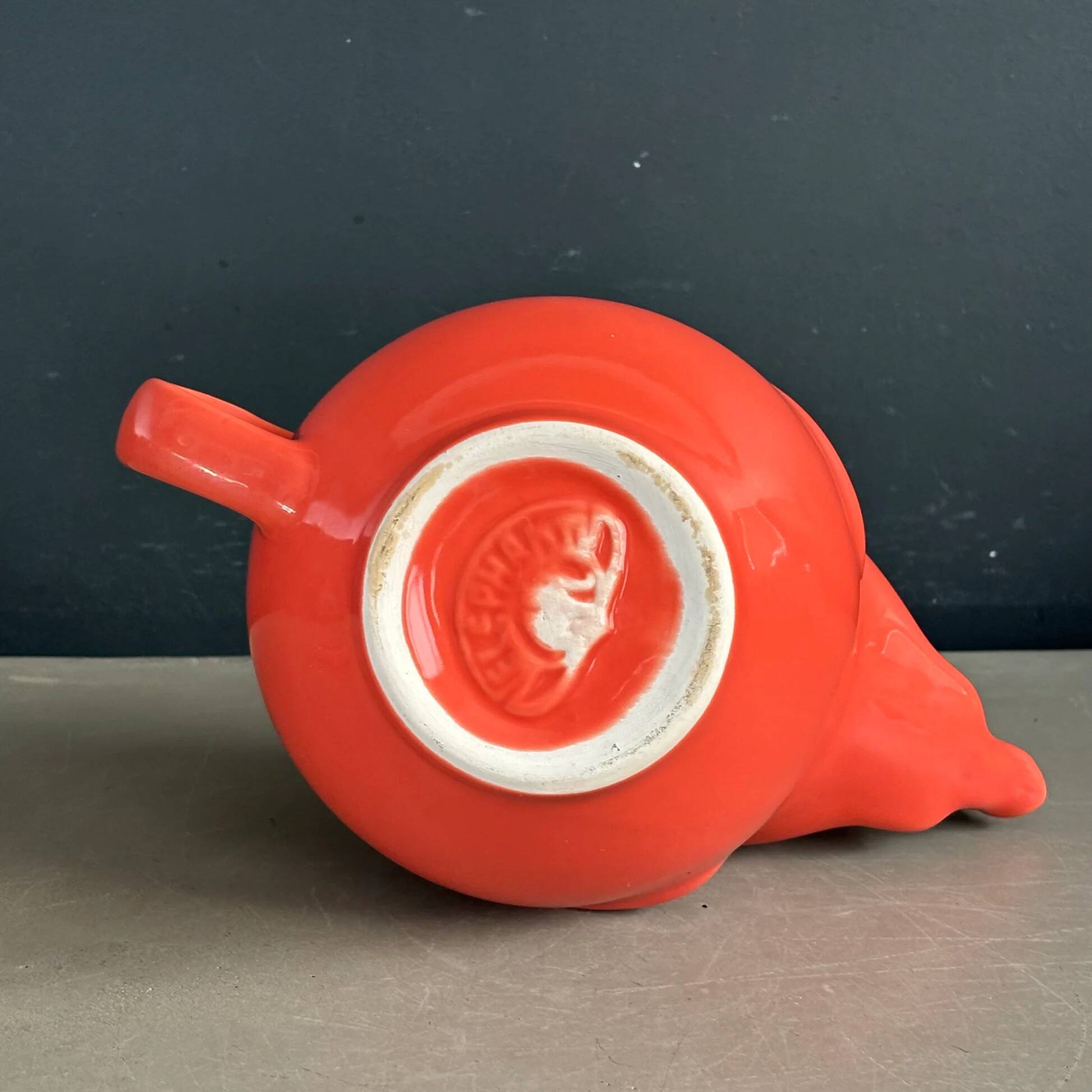 Large coral-coloured elephant teapot.