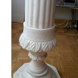 Saddle column in fluted white marble with floral motifs.
