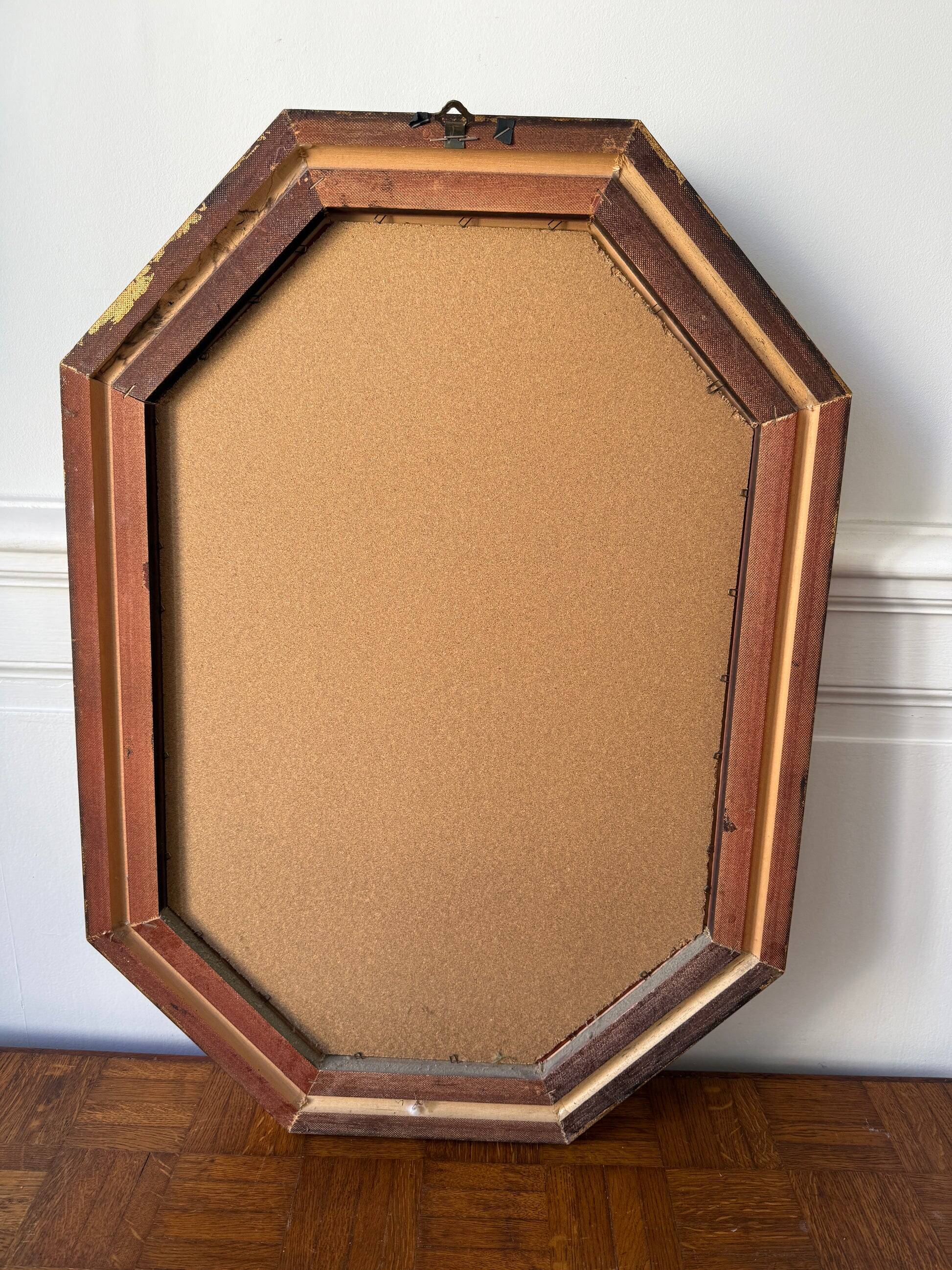 Octagonal gold mirror with copper reflections.