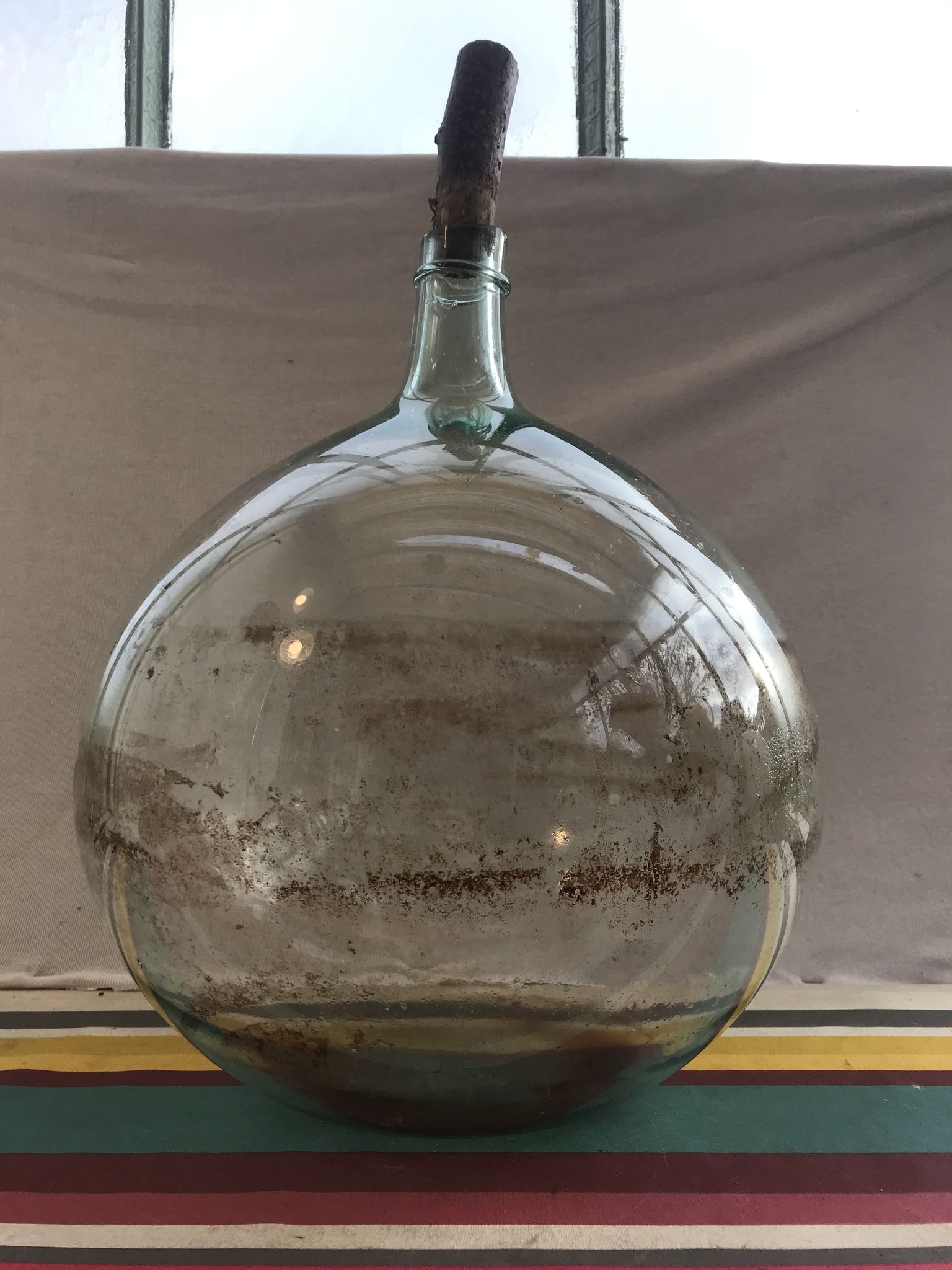 Former green glass demijohn