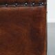 Cognac-colored sheepskin stool with decorative studs