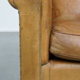 Stylish patinated vintage sheepskin armchair with a comfortable seat