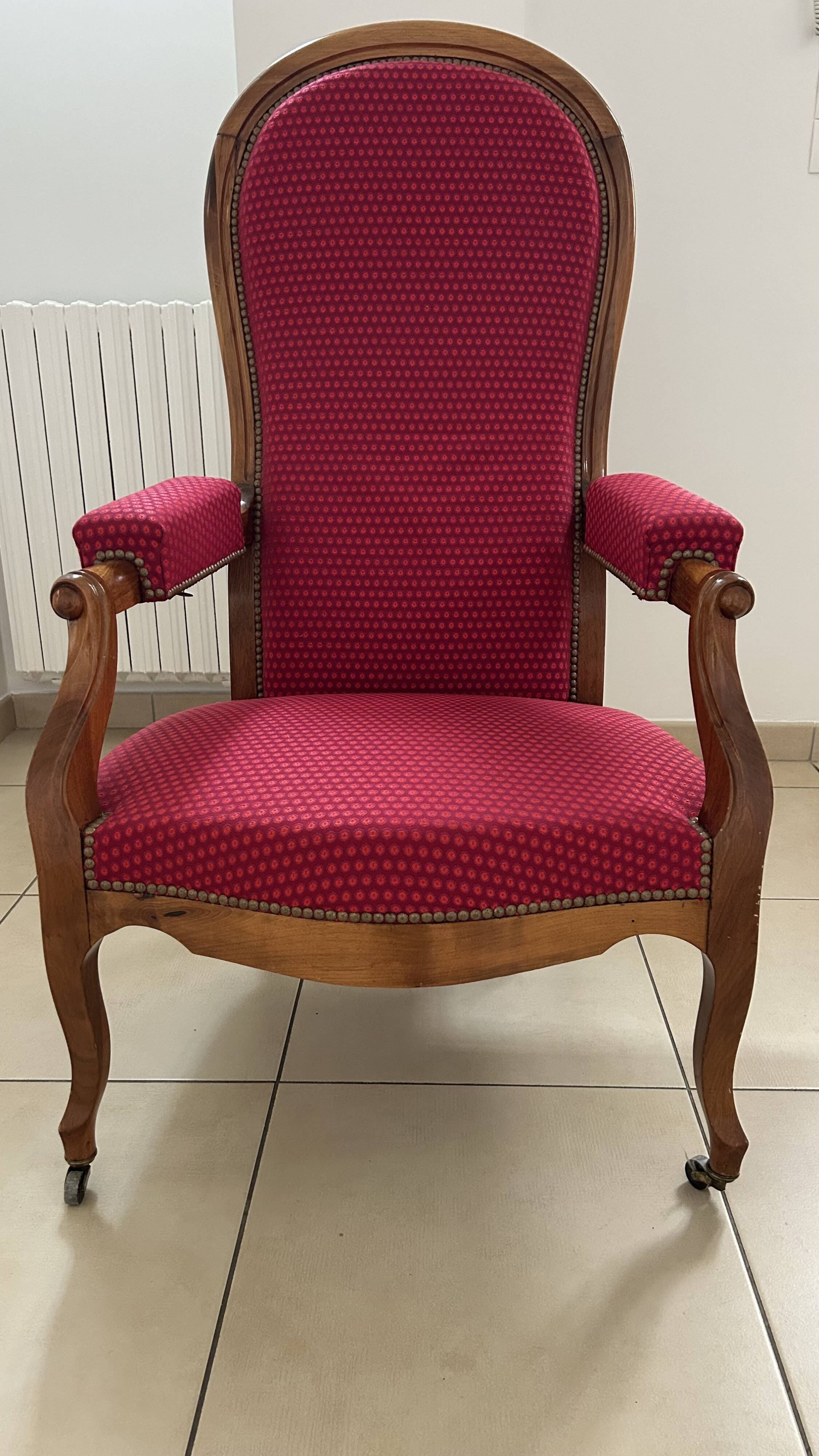 Antique Louis Philippe armchair in walnut and red fabric.