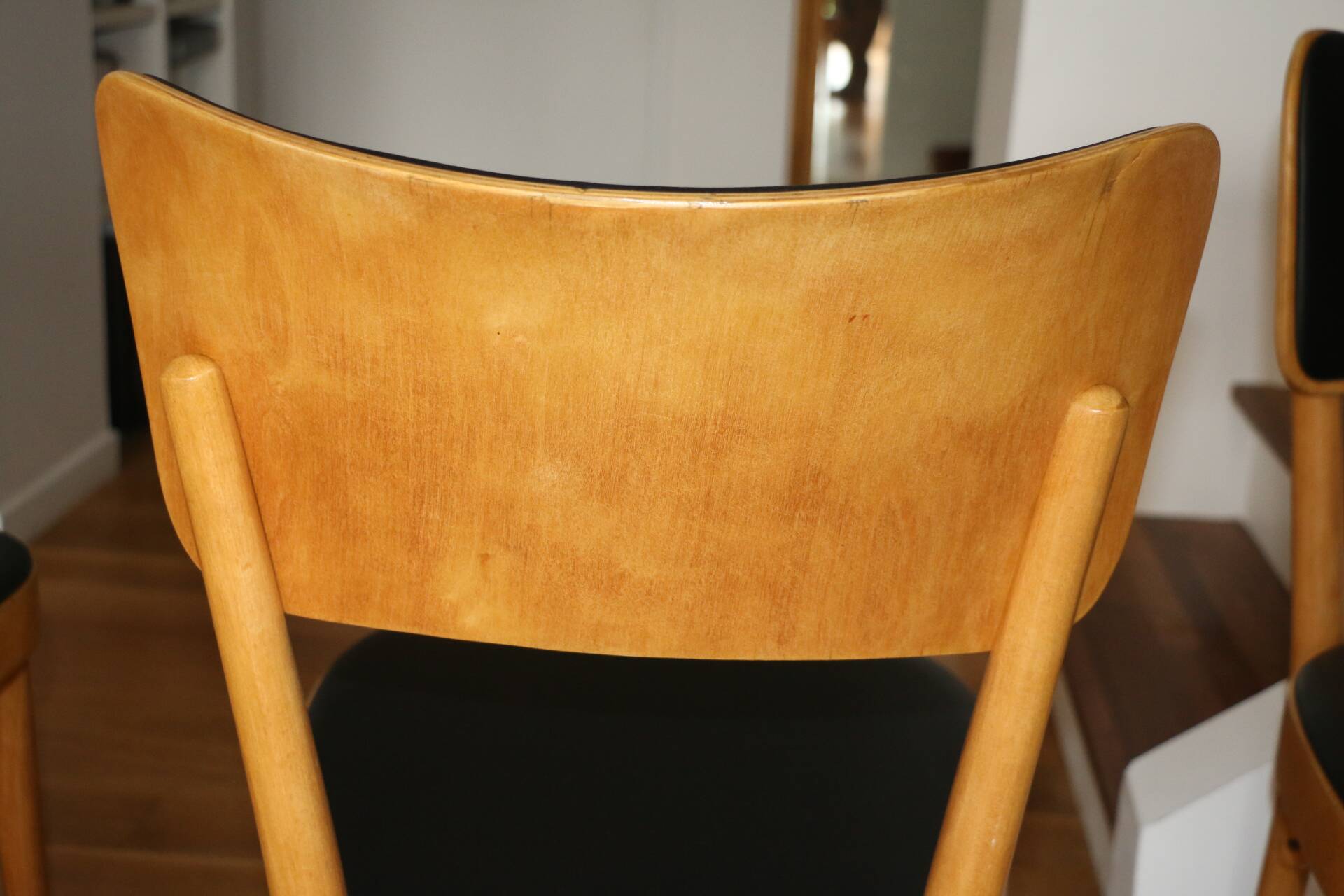5 baumann chairs with large backs in black faux leather.