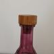 Vintage pink pressed glass carafe – retro decorative bottle with wooden stopper.