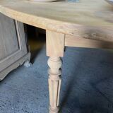 Oval wooden table on wheels.