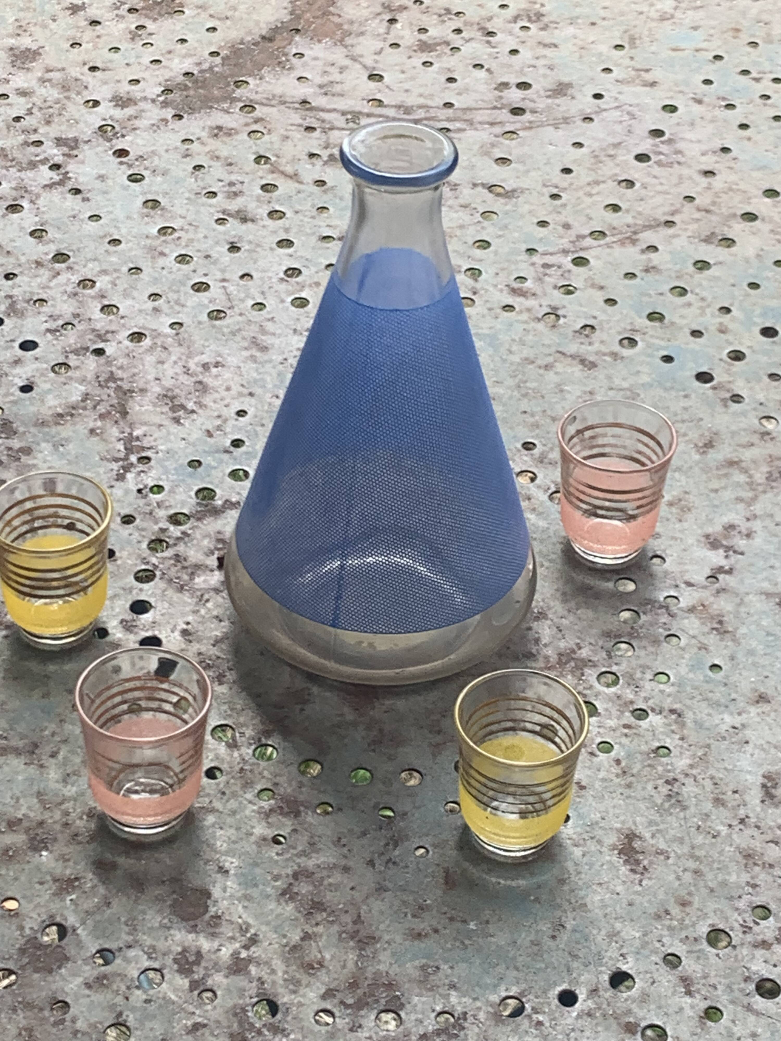 Blue glass liqueur carafe and 4 small vintage granite glasses