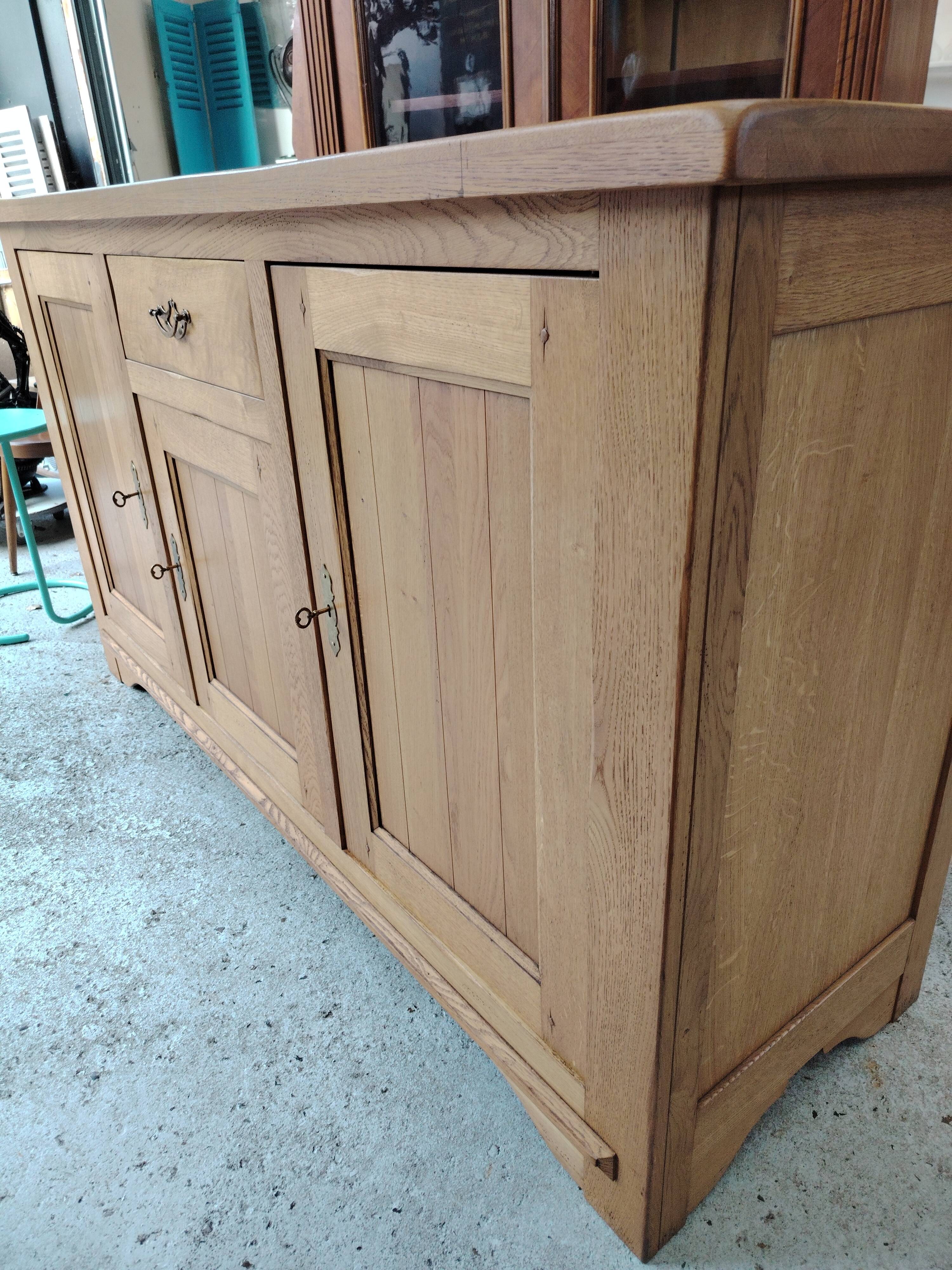 Low sideboard in light solid oak with 3 doors and 1 drawer.