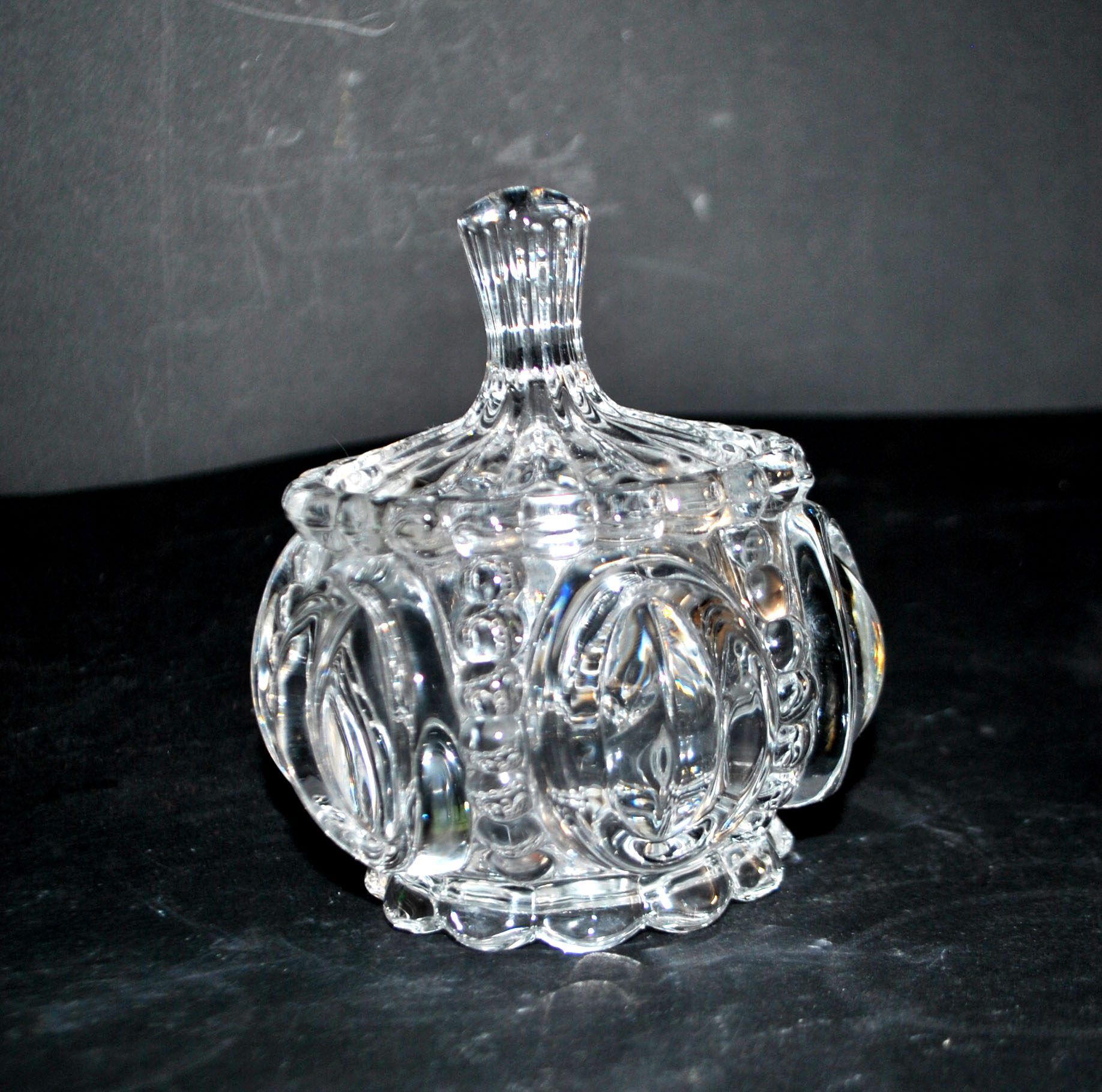 Thick moulded crystal sugar bowl with a beaded and medallion design.