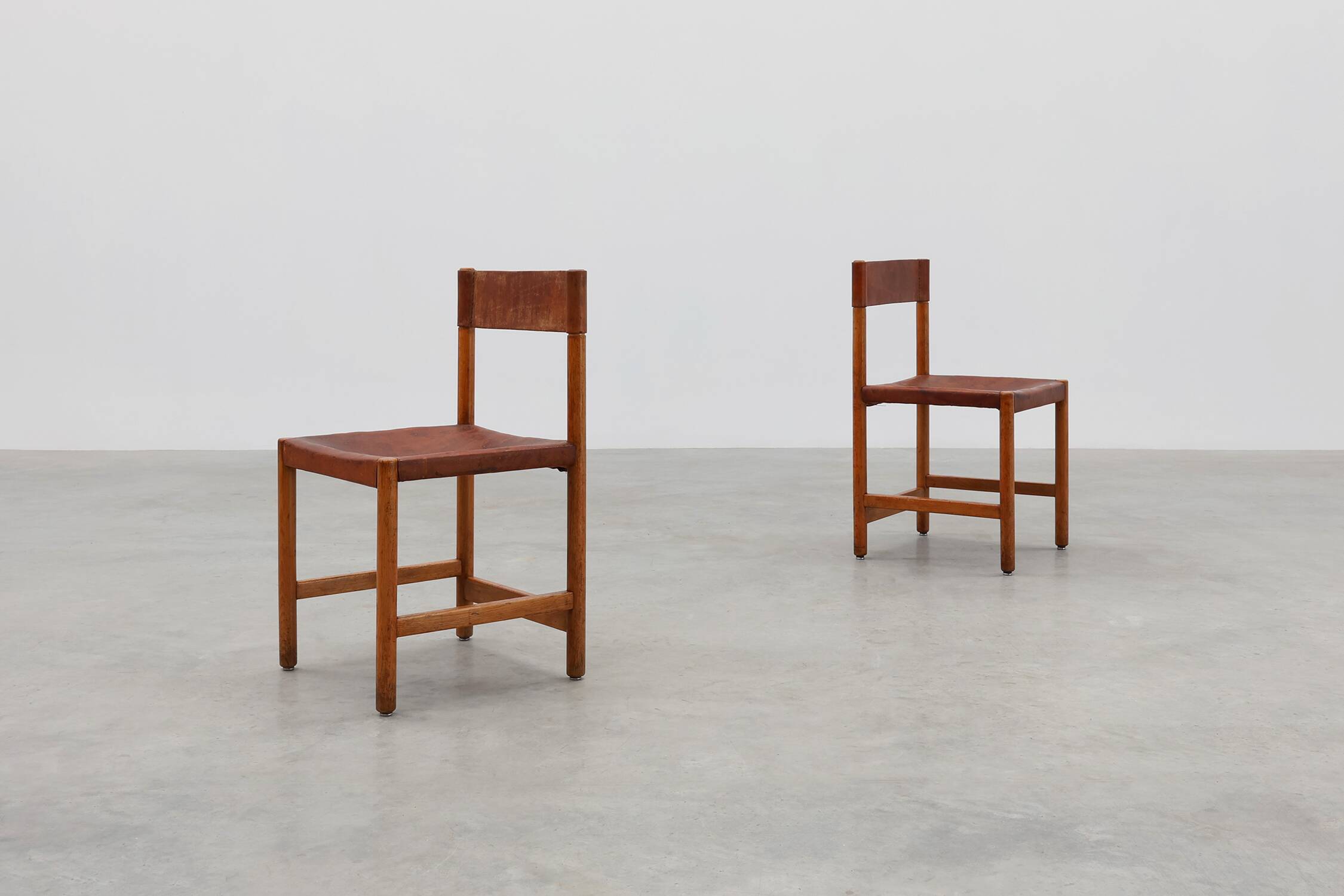Pair of wood and leather Spanish chairs by Jordi Vilanova, ca. 1960