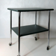 Table serves console with chrome wheels and imitation vintage khaki