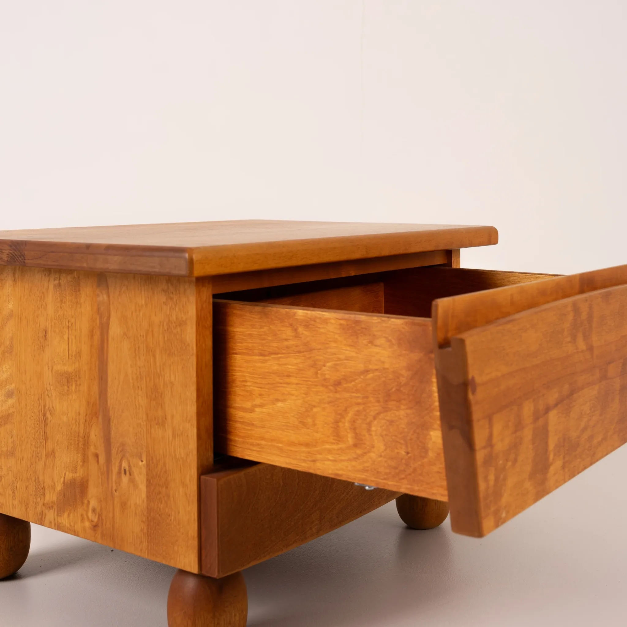 Pair of wooden bedside tables with rounded feet