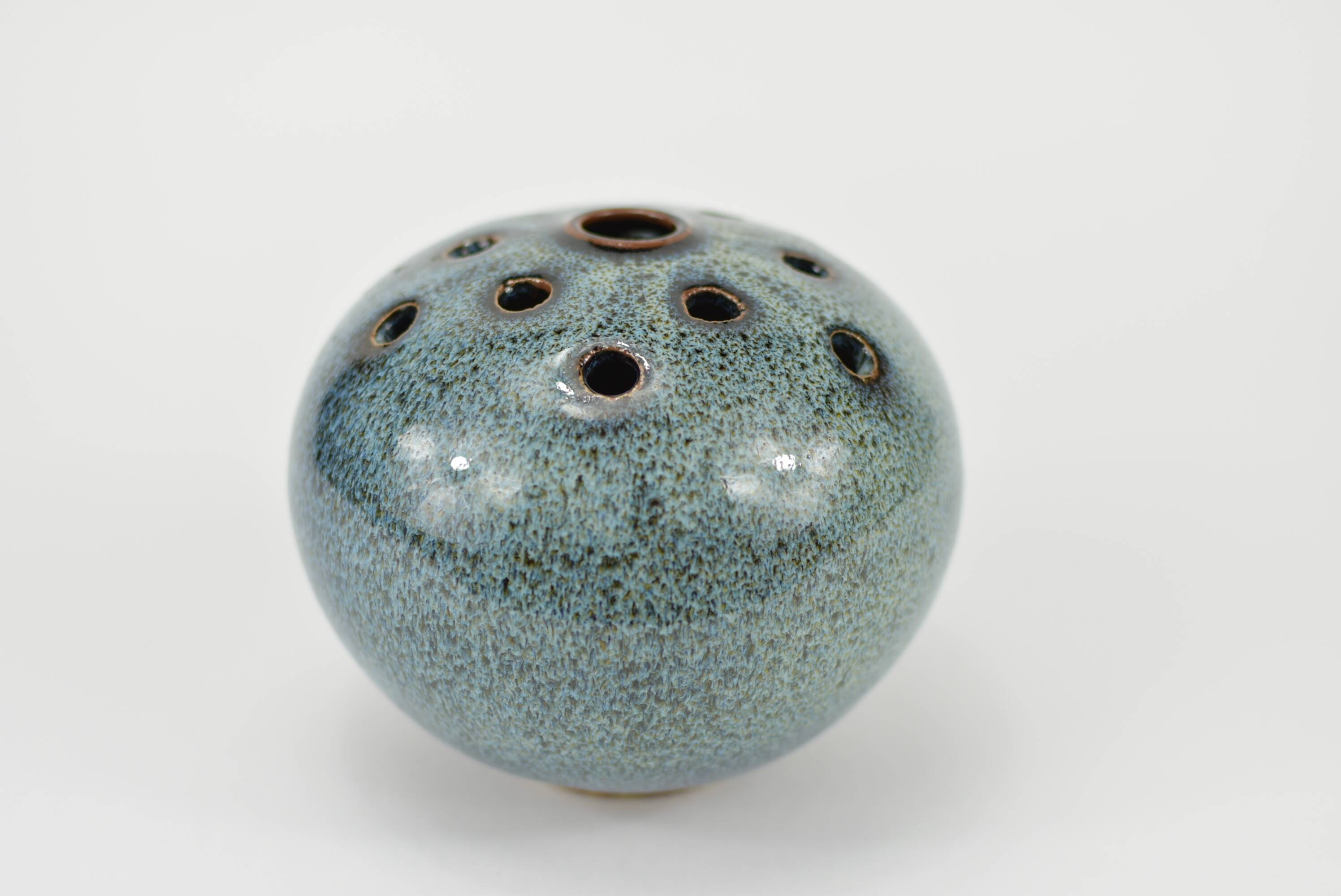 Vase with blue flowers.