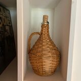 Glass bottle surrounded by wicker