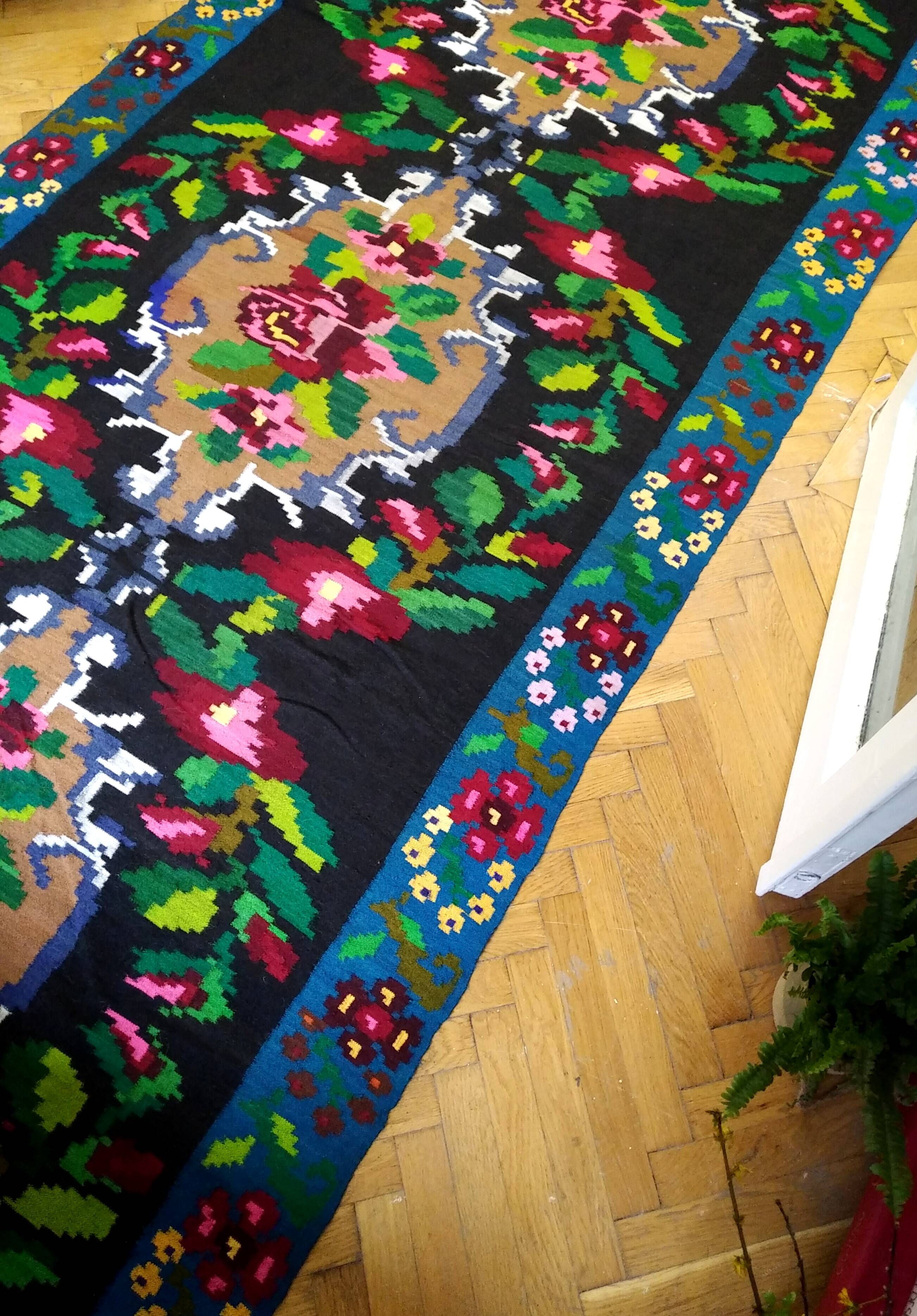 Romanian floral runner rug on blue background